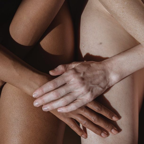 crop model caressing hand of black partner