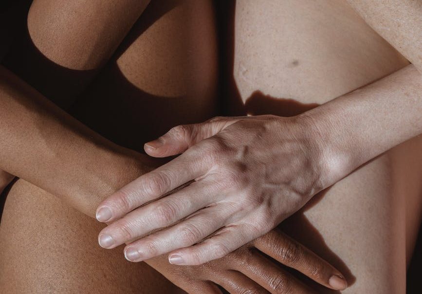 crop model caressing hand of black partner